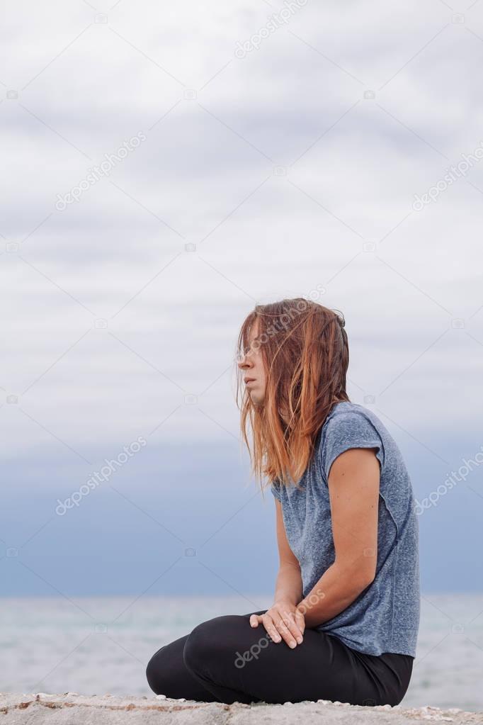 Woman alone and depressed at seaside