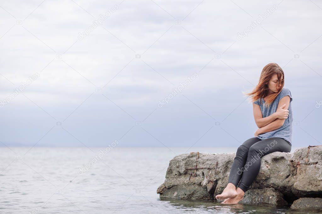 Woman alone and depressed at seaside