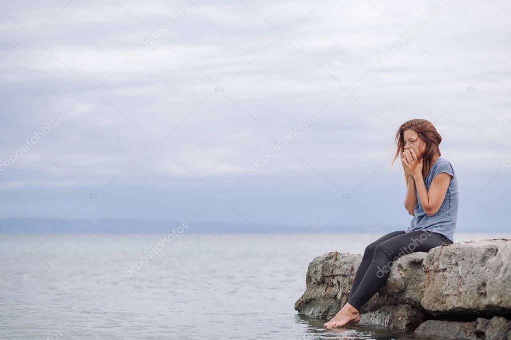 Woman alone and depressed at seaside