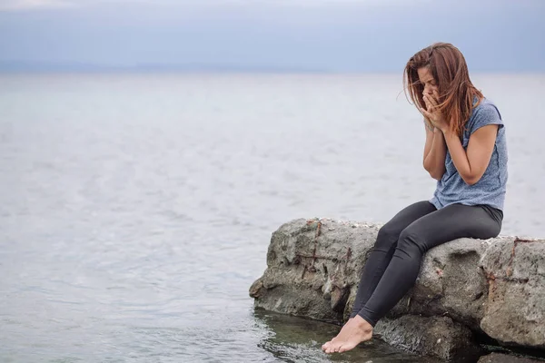 Woman alone and depressed at seaside Royalty Free Stock Images