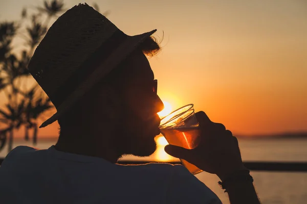 Młody człowiek, zachód słońca na plaży bar — Zdjęcie stockowe