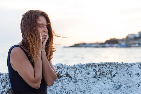 Young woman feeling sad on the pier — Stock Photo, Image