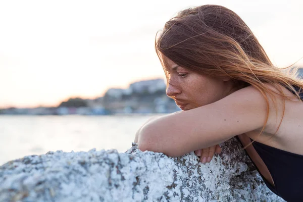 Young woman feeling sad on the pier — Stock Photo, Image