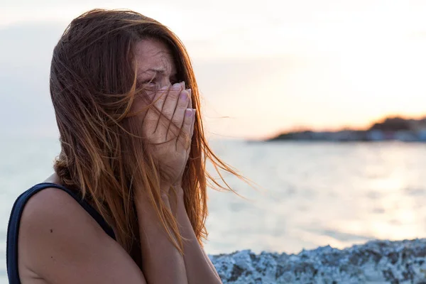 Young woman feeling sad on the pier — Stock Photo, Image