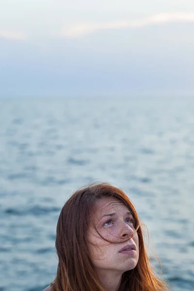 Young woman feeling sad on the pier — Stock Photo, Image