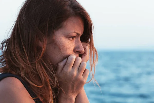 Young woman feeling sad by the sea — Stock Photo, Image