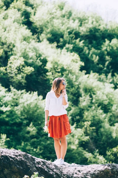 Young woman with flowers in nature — Stock Photo, Image