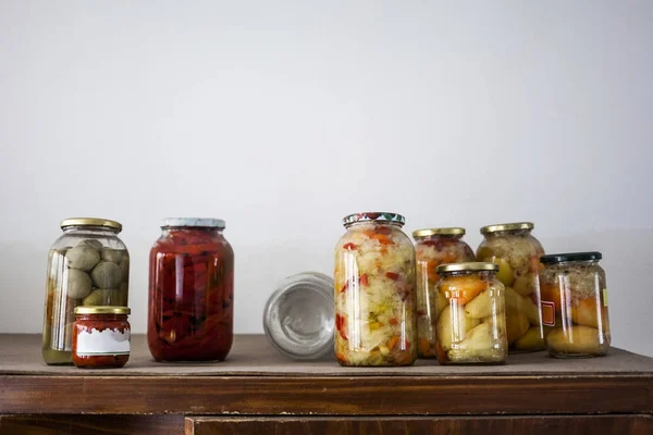 Food preserving for autumn winter time. Jars with pickled vegetables in cellar