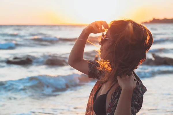 サンセット ビーチで波を楽しんでいる若い女性 — ストック写真