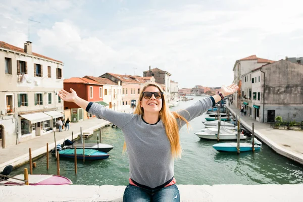 Young Female Traveler Sitting Bridge Her Arms Stretched Murano Venice Royalty Free Stock Photos