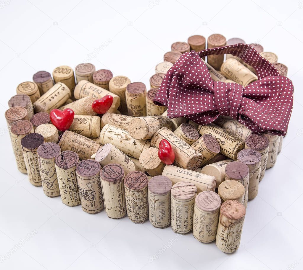 Father's day celebration valentine made of wine corks coupled with red hearts and a burgundy dotted bow tie.