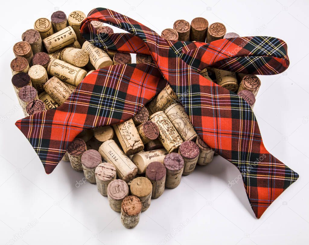 Father's day celebration valentine made of wine corks coupled with red hearts and a checkered bow tie