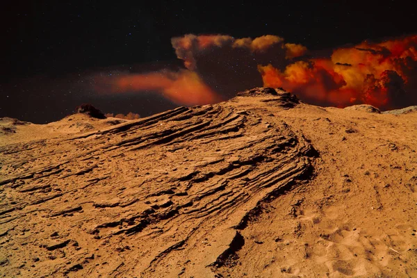 Orange desert landscape and orange dramatic clouds and sky with stars