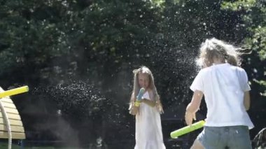 Çocuklar dışarıda farklı oyunlar oynuyor. Çocuklar dışarıda birlikte eğleniyorlar. Mutlu kızlar oyun alanında oynamayı sever. Çocuklar oyun parkına neşeyle su döker..