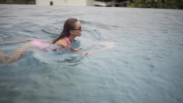 Sexy Meisje Zwemt Het Zwembad Ontspant Een Badpak Met Een — Stockvideo