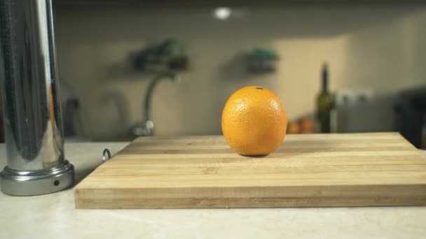 Man Cuts Orange Knife Board — Stock Video