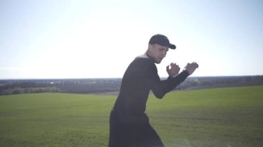 Bir adam tarlada, tarlada, adadaki bir adamda, bir gölgeyle mücadele ediyor.