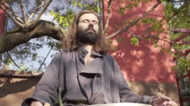 Bir qigong ustası gong ve kristal kase kullanarak meditasyon yapar, Kristal Tibet şarkı kasesi, bir usta vücut için enerji alır.