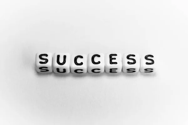 White cubes with word SUCCESS on white background — Stock Photo, Image