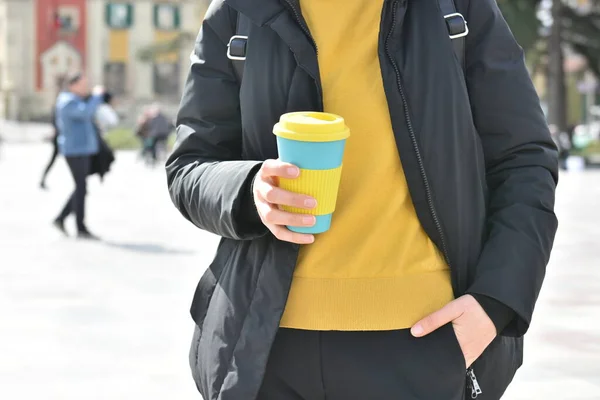 Woman hand holds eco coffee cup.Sustainable lifestyle concept.