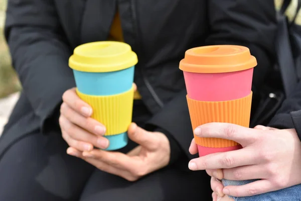 Two females holding eco coffee cup.Sustainable lifestyle concept. — Stockfoto