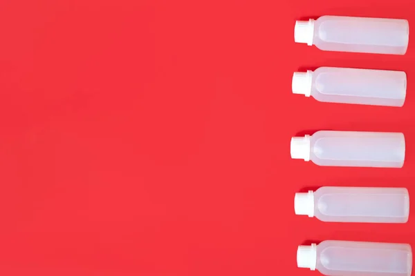 Close up antibacterial gel for hands sanitizer on red background.