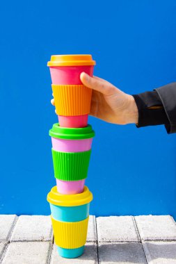 One womans hand taking eco coffee cup. Zero waste concept.