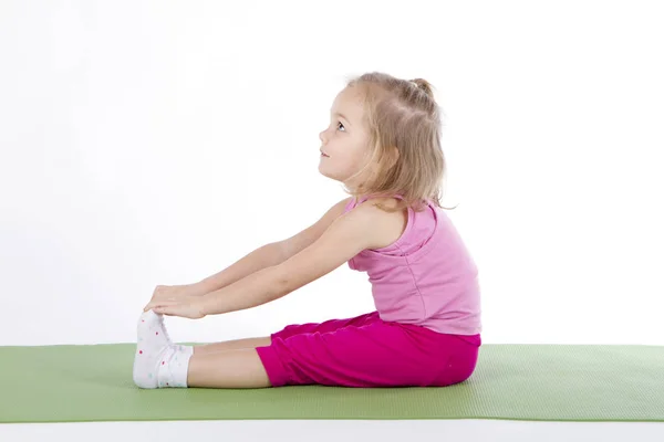 Child doing gymnastics on a mat — Stock Photo, Image