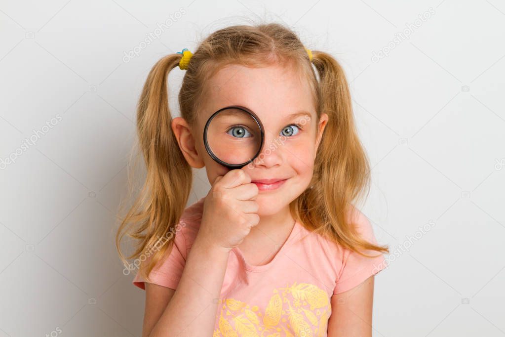 child with magnifier