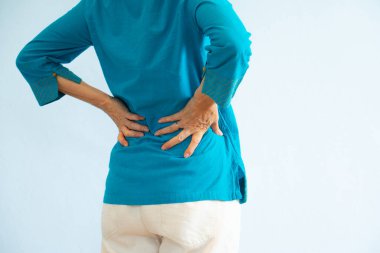 An old asian woman in blue blouse getting backache, white backgr