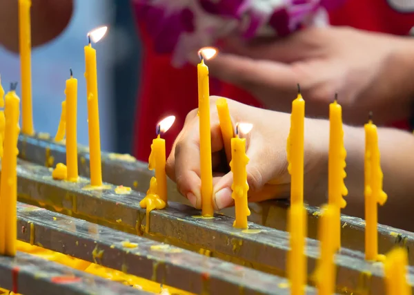 Vela amarilla con llama aligerar de la gente budista que vino t — Foto de Stock