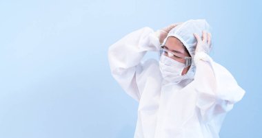 COVID 19 enfeksiyonunu korumak için maske, gözlük ve takım elbise takan bir doktor.