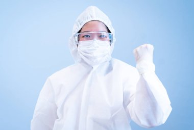 COVID 19 enfeksiyonunu korumak için maske, gözlük ve takım elbise takan bir doktor.