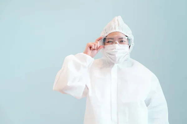 A doctor wearing personal protective equipment including mask, goggle, and suit to protect COVID 19 infection