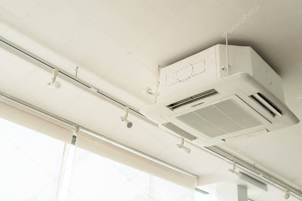picture of cassette type air conditioner or cooling system on the ceiling in the house. business and interior design concept