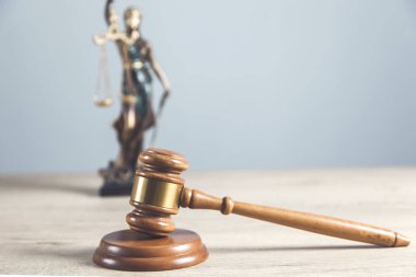 Tahta yargıç ve gri duvarlı kadın.