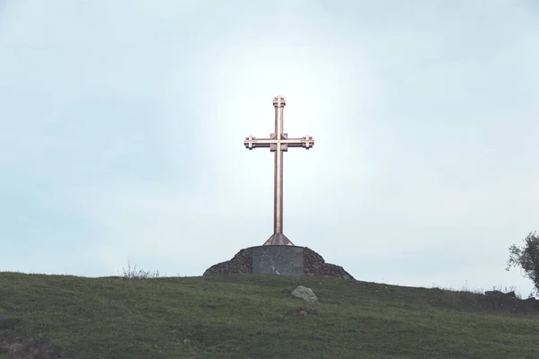 the cross in the green grass background