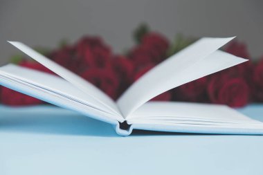 Masasında gül buketi olan not defteri.