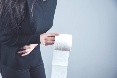 Üzgün kadın, karın ağrısı, el tuvalet kağıdı.