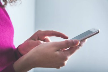 Gri duvar arkaplanındaki akıllı telefon.