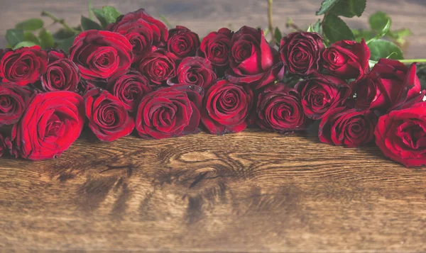 Κόκκινα Τριαντάφυλλα Στο Ξύλινο Γραφείο — Φωτογραφία Αρχείου