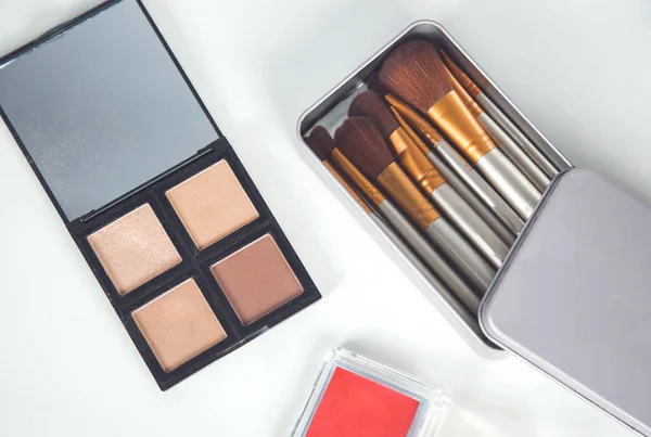 makeup accessories on the white desk background