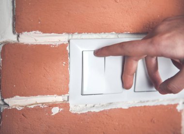 Bir kadın evdeki ışığı yakar