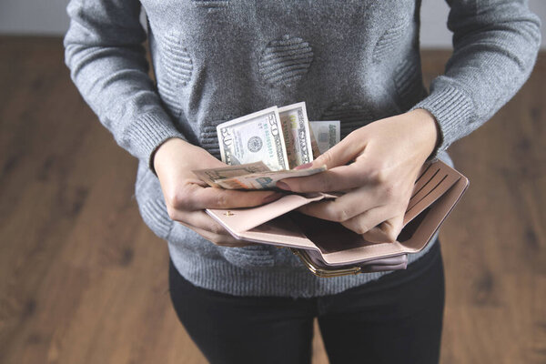 woman hand money with wallet on grey background