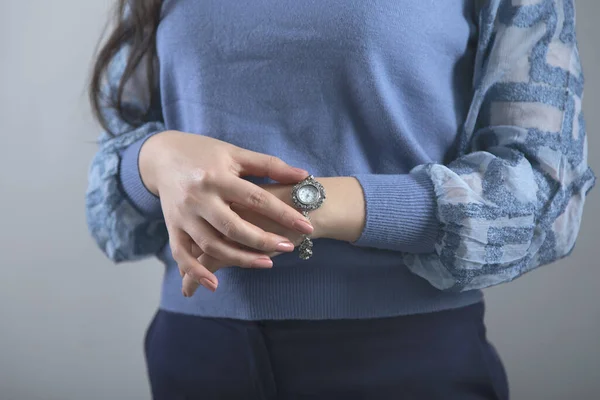 woman hand watch on grey background