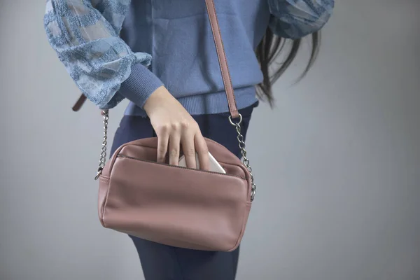 woman hand pink bag with smart phone