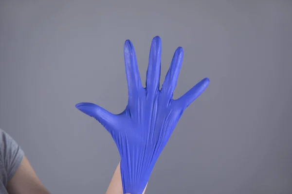 Woman Hand Blue Glove Grey Background — Stock Photo, Image