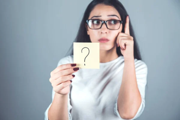 thinking woman hand question mark sign on dark background