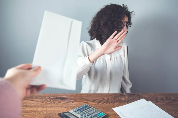 woman hand stop sign in bribe on desk