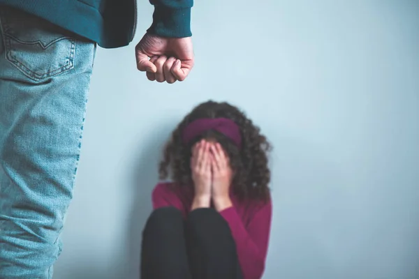 man beat woman on the grey background